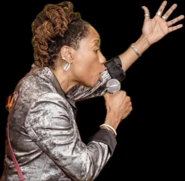 Rosie Parke performing on stage with a microphone